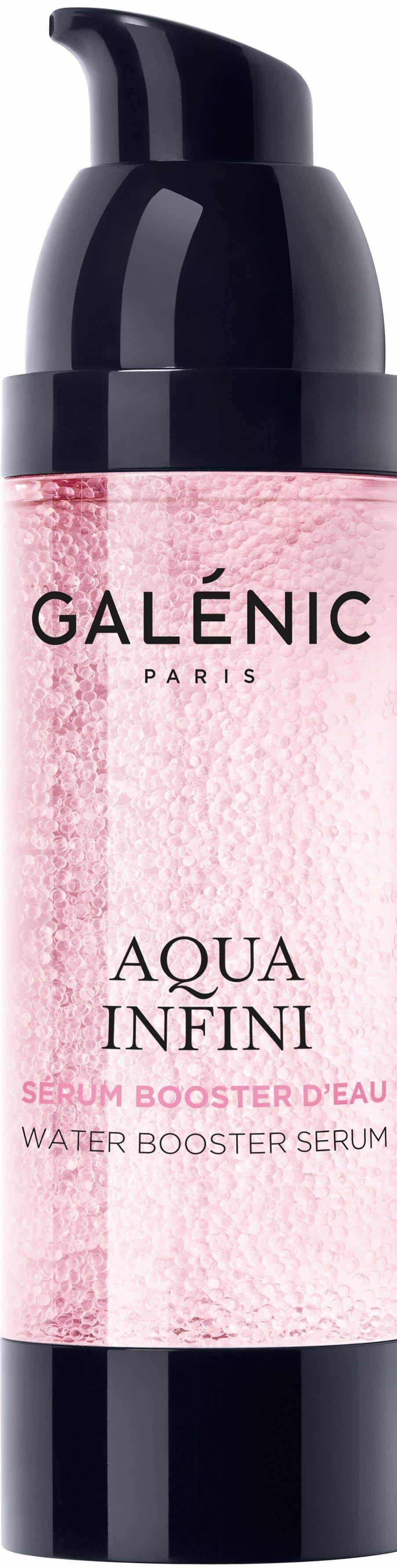 Galenic Aqua Infini Water Booster Serum in a sleek, pale-pink glass bottle with a black pump, shown beside its white and grey-green branded box.