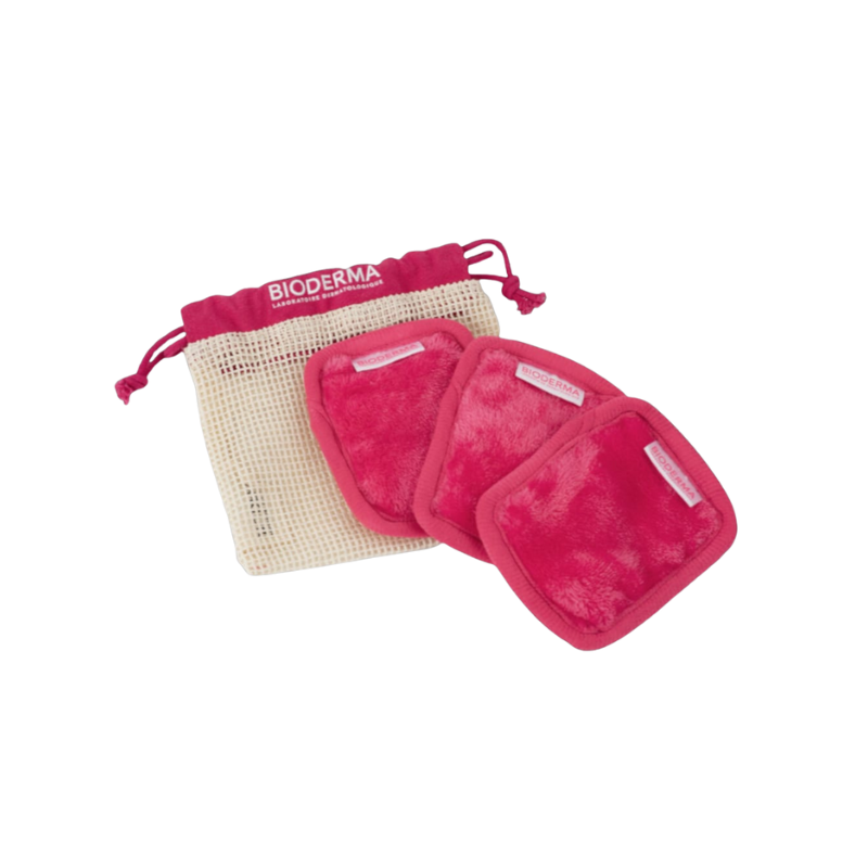 Set of pink pouches with a drawstring bag featuring Bioderma branding on a white background.