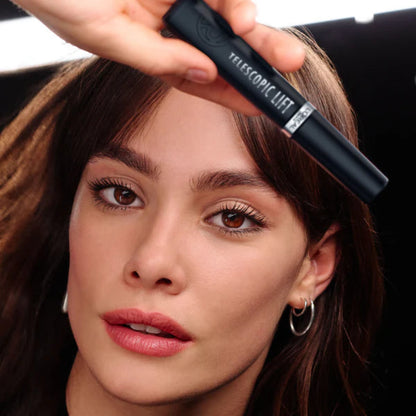 Woman holding a telescopic clip in front of her face